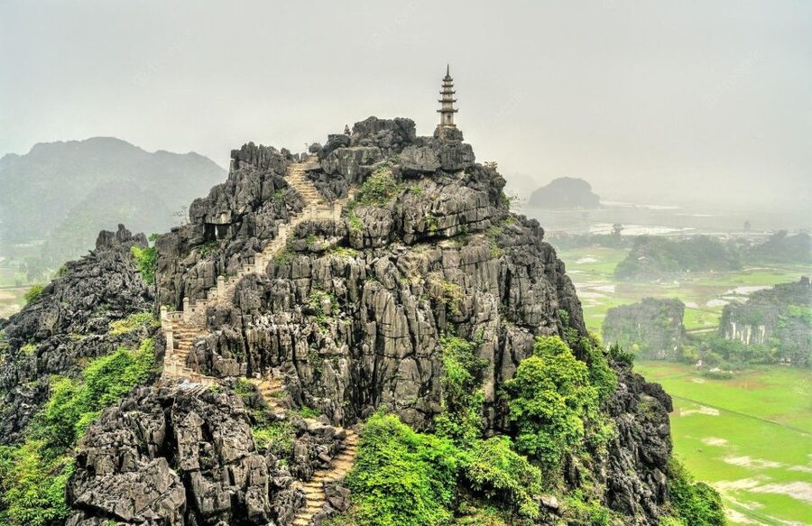 Hanoi: Guided Full-Day Hoa Lu, Trang An and Mua Cave Tour - Cycling through a village